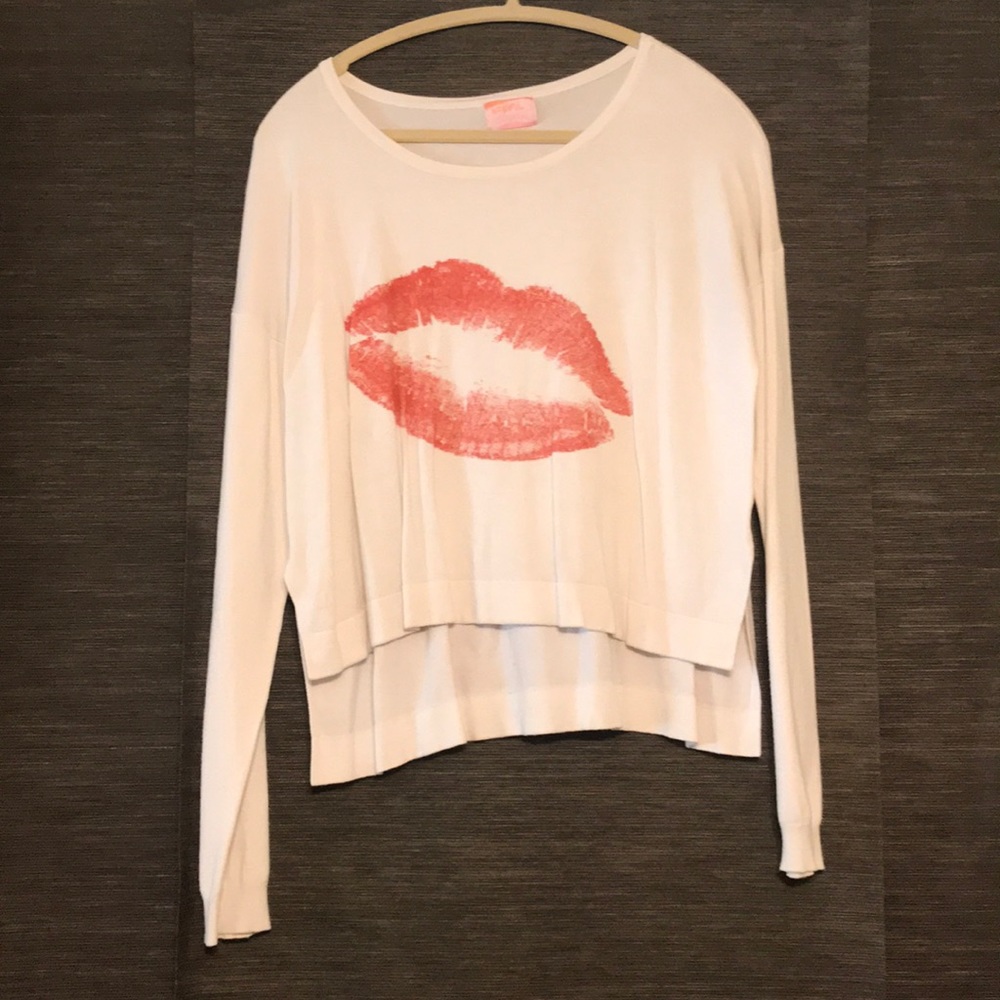White sweater with red lipstick kiss